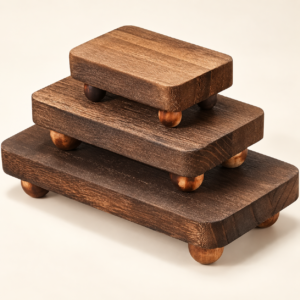 Three TAVEN brown wooden display risers stacked from large to small on an ivory background